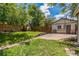 A spacious backyard with a well-maintained lawn, a concrete patio, and a charming wooden fence at 710 Raleigh St, Denver, CO 80204