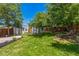 Expansive backyard featuring lush greenery, mature trees, and storage sheds at 710 Raleigh St, Denver, CO 80204