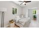 Bedroom with light gray walls, hardwood floors, and a large window overlooking the backyard at 710 Raleigh St, Denver, CO 80204