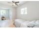 Bedroom features hardwood floors, fan, a large window overlooking the backyard and a small sitting area at 710 Raleigh St, Denver, CO 80204