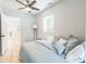 Bedroom with light gray walls, hardwood floors, fan, and a large window overlooking the backyard at 710 Raleigh St, Denver, CO 80204