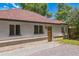 Cozy single-story home with red roof, a charming wooden door, and a well-maintained front yard at 710 Raleigh St, Denver, CO 80204