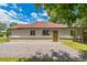 Charming single-story home with a gravel driveway and a well-manicured lawn at 710 Raleigh St, Denver, CO 80204
