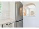 Kitchen showcasing stainless steel refrigerator and dishwasher, with a pass-through to the living area at 710 Raleigh St, Denver, CO 80204