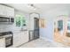 Bright kitchen features stainless steel appliances, modern cabinetry, marble floors and views of the backyard at 710 Raleigh St, Denver, CO 80204
