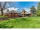 Lush backyard featuring a patio, outdoor seating, and a play structure at 4031 S Hudson Way, Cherry Hills Village, CO 80113
