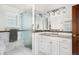 Modern bathroom featuring marble tile, glass shower and sleek white vanity at 4031 S Hudson Way, Cherry Hills Village, CO 80113