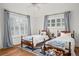 Bright bedroom featuring two wooden beds, shuttered windows and hardwood floors at 4031 S Hudson Way, Cherry Hills Village, CO 80113