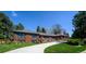 Beautiful brick home with a well-manicured lawn and curved driveway at 4031 S Hudson Way, Cherry Hills Village, CO 80113