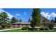 Charming single-story home with a brick facade and lush green lawn at 4031 S Hudson Way, Cherry Hills Village, CO 80113