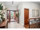 Inviting foyer with wooden door, tiled floor, and elegant decor at 4031 S Hudson Way, Cherry Hills Village, CO 80113