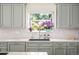 Stylish kitchen sink with a view of the backyard and custom cabinetry at 4031 S Hudson Way, Cherry Hills Village, CO 80113