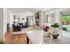 Bright living room featuring a stone fireplace, hardwood floors, and backyard access at 4031 S Hudson Way, Cherry Hills Village, CO 80113
