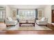 Cozy living room with large window, comfortable seating, and a stylish rug at 4031 S Hudson Way, Cherry Hills Village, CO 80113