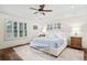 Serene main bedroom with hardwood floors, plantation shutters, and a stylish bench at 4031 S Hudson Way, Cherry Hills Village, CO 80113