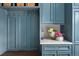 Custom mudroom with blue cabinets, bench seating, and countertop detail at 4031 S Hudson Way, Cherry Hills Village, CO 80113