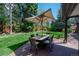 Outdoor patio with a dining table, chairs, and an umbrella, perfect for entertaining at 4031 S Hudson Way, Cherry Hills Village, CO 80113