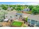 An aerial view features a charming backyard with well-kept lawn, brick patio, and a second story porch at 12651 Elm St, Thornton, CO 80241