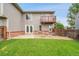 Nice backyard with green lawn, patio, balcony, and privacy fence at 12651 Elm St, Thornton, CO 80241