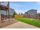 Backyard with seating area, green lawn, privacy fence, and trees at 12651 Elm St, Thornton, CO 80241