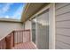 View from balcony through sliding glass door with wood railing at 12651 Elm St, Thornton, CO 80241