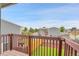 Balcony with wood railings offering neighborhood views on a sunny day at 12651 Elm St, Thornton, CO 80241