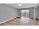 Bedroom with hardwood flooring, a large window that provides plenty of natural light, and sliding glass doors to a balcony at 12651 Elm St, Thornton, CO 80241