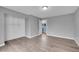 Spacious bedroom features hardwood floors, neutral gray paint, and an attached closet with shelving for plenty of storage at 12651 Elm St, Thornton, CO 80241
