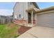 Charming two-story home exterior with brick accents, gray siding, a well-maintained lawn, and an attached garage at 12651 Elm St, Thornton, CO 80241