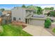 This charming home has an attached garage, a well-kept lawn and is accented by stylish brickwork at 12651 Elm St, Thornton, CO 80241