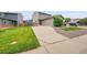 Charming home exterior with a large driveway and well-manicured lawn at 12651 Elm St, Thornton, CO 80241