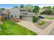 Charming two-story home with a large front yard, solar panels, and an attached two car garage at 12651 Elm St, Thornton, CO 80241