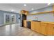 Bright eat-in kitchen with stainless steel appliances, wood cabinets, butcher block countertops and double doors to the backyard at 12651 Elm St, Thornton, CO 80241