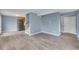 Light-filled living room with light blue walls, hardwood floors, and modern finishes at 12651 Elm St, Thornton, CO 80241