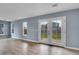 Bright living area boasting hardwood floors, large windows, and French door access at 12651 Elm St, Thornton, CO 80241