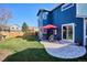 Backyard featuring a lawn, patio, red umbrella, and fenced perimeter at 4175 S Andes St, Aurora, CO 80013