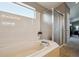 Bathroom featuring a soaking tub with window and glass enclosed shower at 4175 S Andes St, Aurora, CO 80013