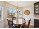 Cozy dining area featuring a round table set next to a window with natural light at 4175 S Andes St, Aurora, CO 80013