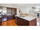 Modern kitchen featuring stainless steel appliances, wood cabinets, and a double sink at 4175 S Andes St, Aurora, CO 80013
