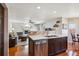 Modern kitchen with stainless steel appliances, ample counter space, and an open view into the cozy living room at 4175 S Andes St, Aurora, CO 80013
