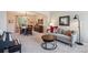 Comfortable living room with neutral-toned furniture, carpet, and stylish décor adjacent to the dining area at 4175 S Andes St, Aurora, CO 80013