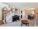 Open-concept space with a staircase, dining area, and living room, blending seamlessly for modern living at 4175 S Andes St, Aurora, CO 80013