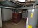 Unfinished basement with water heater, shelving and old furnace at 1346 S Logan St, Denver, CO 80210