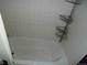 Standard bathtub with white tiled walls at 1346 S Logan St, Denver, CO 80210