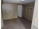 Neutral carpeted bedroom with paneled walls and a white painted door at 1346 S Logan St, Denver, CO 80210