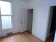 Bedroom with hardwood floors, a frosted window, and ample closet space at 1346 S Logan St, Denver, CO 80210