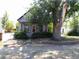 Charming home with a large tree in the front yard at 1346 S Logan St, Denver, CO 80210