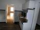 Vintage kitchen with microwave oven and view into a wood floor living space at 1346 S Logan St, Denver, CO 80210