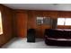 Cozy living room features wood paneling and a comfortable purple couch at 1346 S Logan St, Denver, CO 80210
