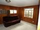 Cozy living room with wood paneling, carpeted floors, and natural light at 1346 S Logan St, Denver, CO 80210